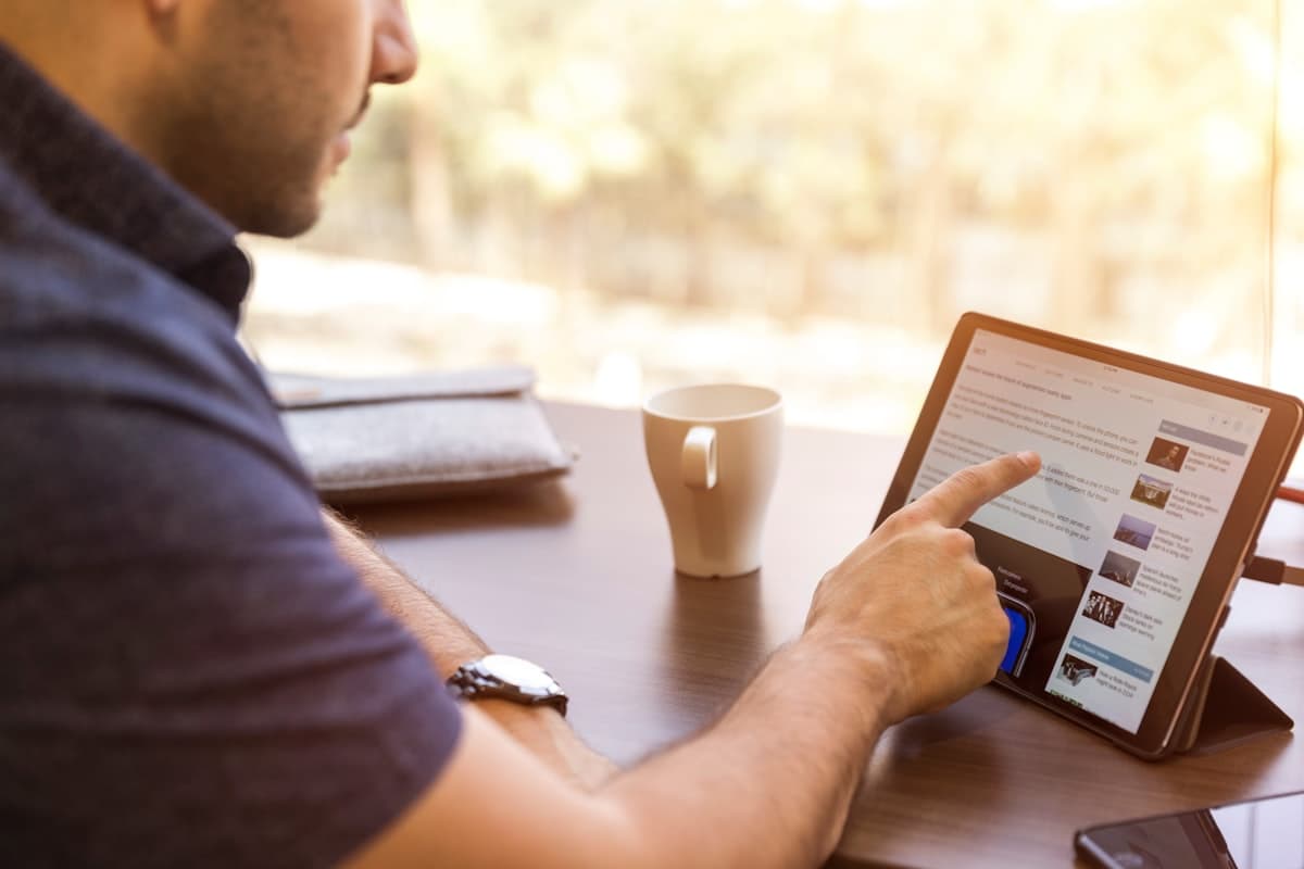 Contractor using tablet to manage jobs and customers in field service software