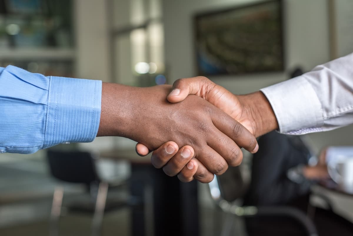 Business handshake representing hiring a home service marketing agency